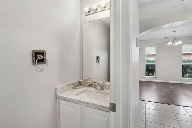 a spacious bathroom with a bathtub sink and mirror
