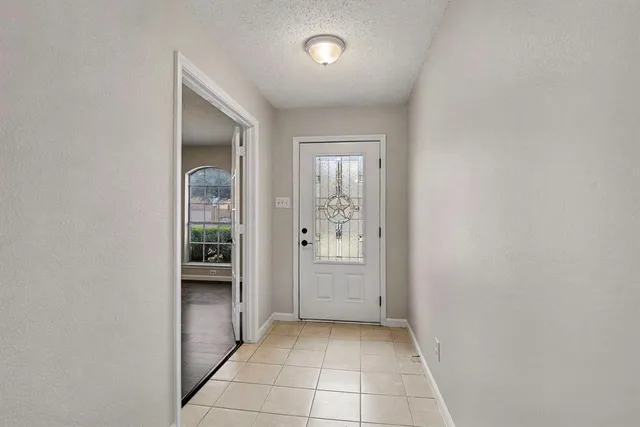 a view of an empty room with a fireplace and a window