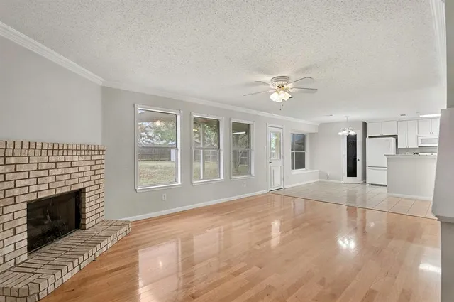 a kitchen with granite countertop white cabinets and stainless steel appliances