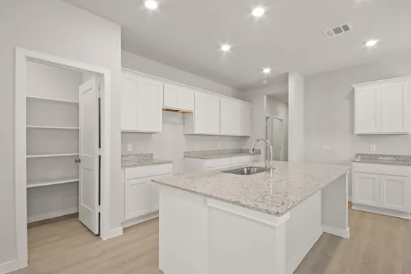 a kitchen with a sink stove and cabinets