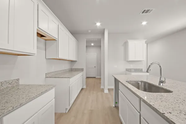 a kitchen that has a sink and a stove