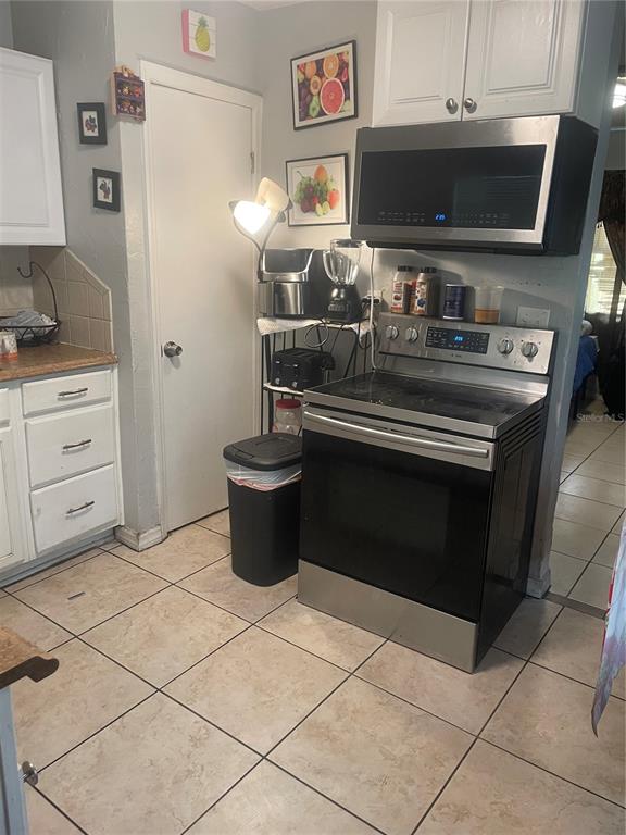 1112 6th Street East Bradenton, FL 34208 - Photo 6 of 9 a kitchen with a stove and a microwave