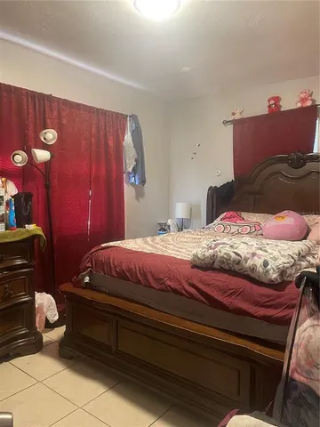 a bedroom with a bed and a lamp with window