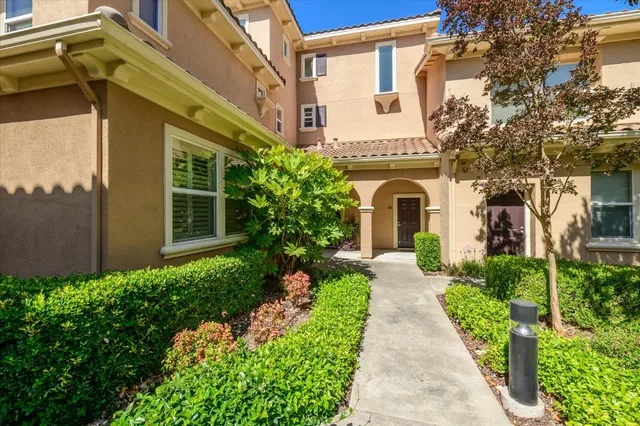 a front view of a house with garden