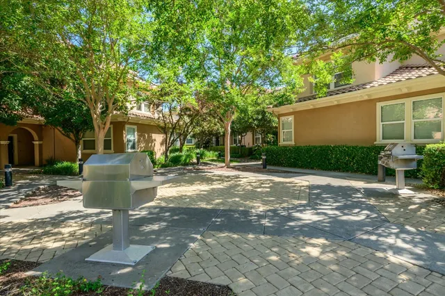 a view of a patio with table and chairs and potted plants