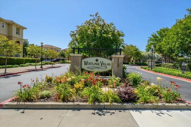 a sign that is sitting in front of flowers
