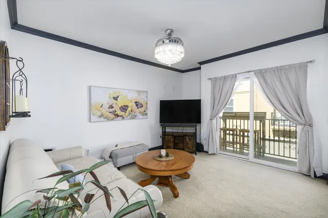 a living room with furniture a flat screen tv and a large window