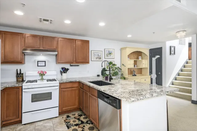 a kitchen with a sink stove and cabinets
