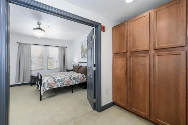 a bedroom with a bed and a chandelier