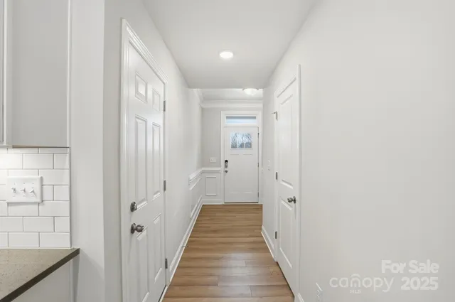 a kitchen with stainless steel appliances granite countertop a sink stove and white cabinets