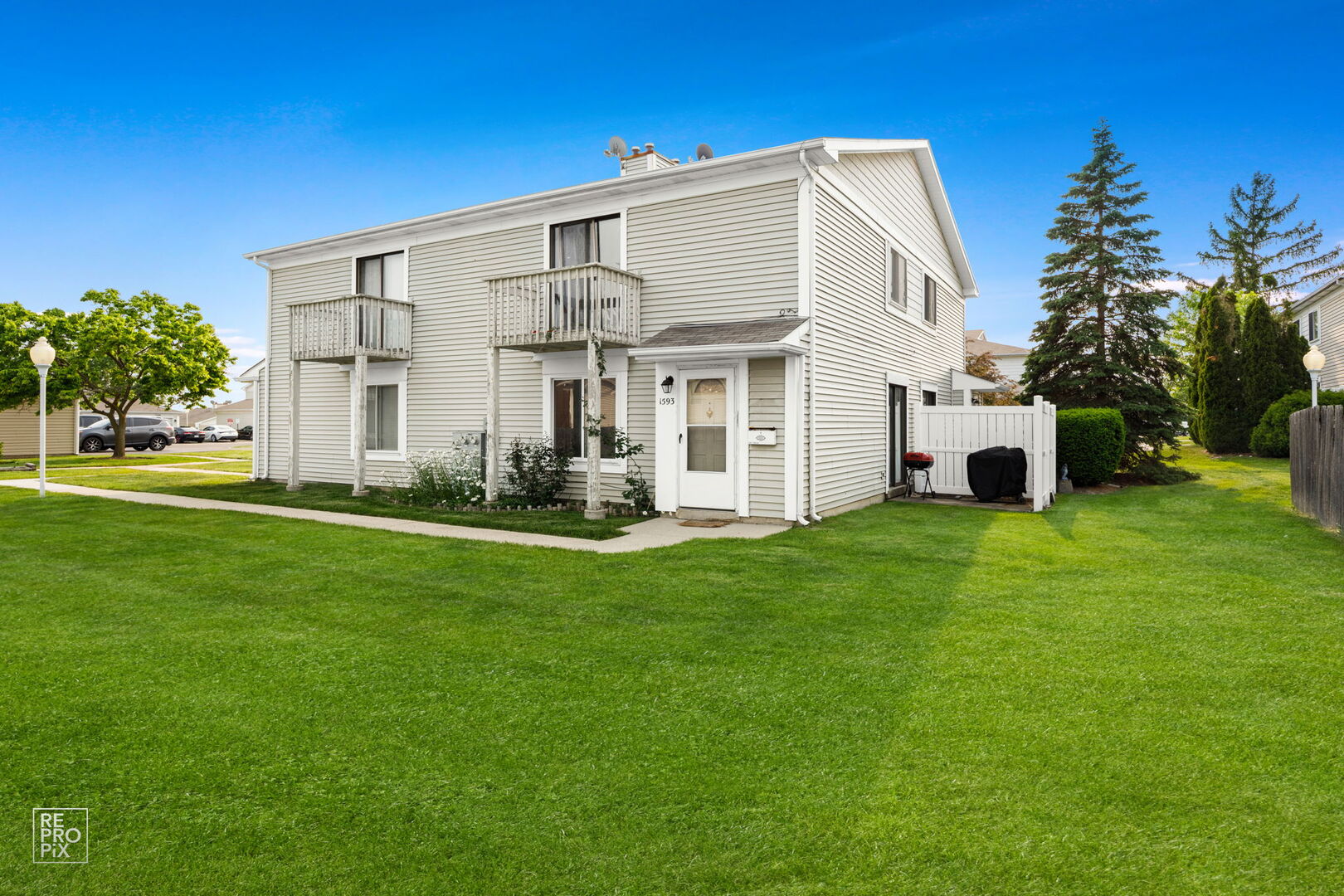 1593 Cornell Place Hoffman Estates, IL 60169 - Photo 15 of 18 a view of a white house with a big yard and potted plants