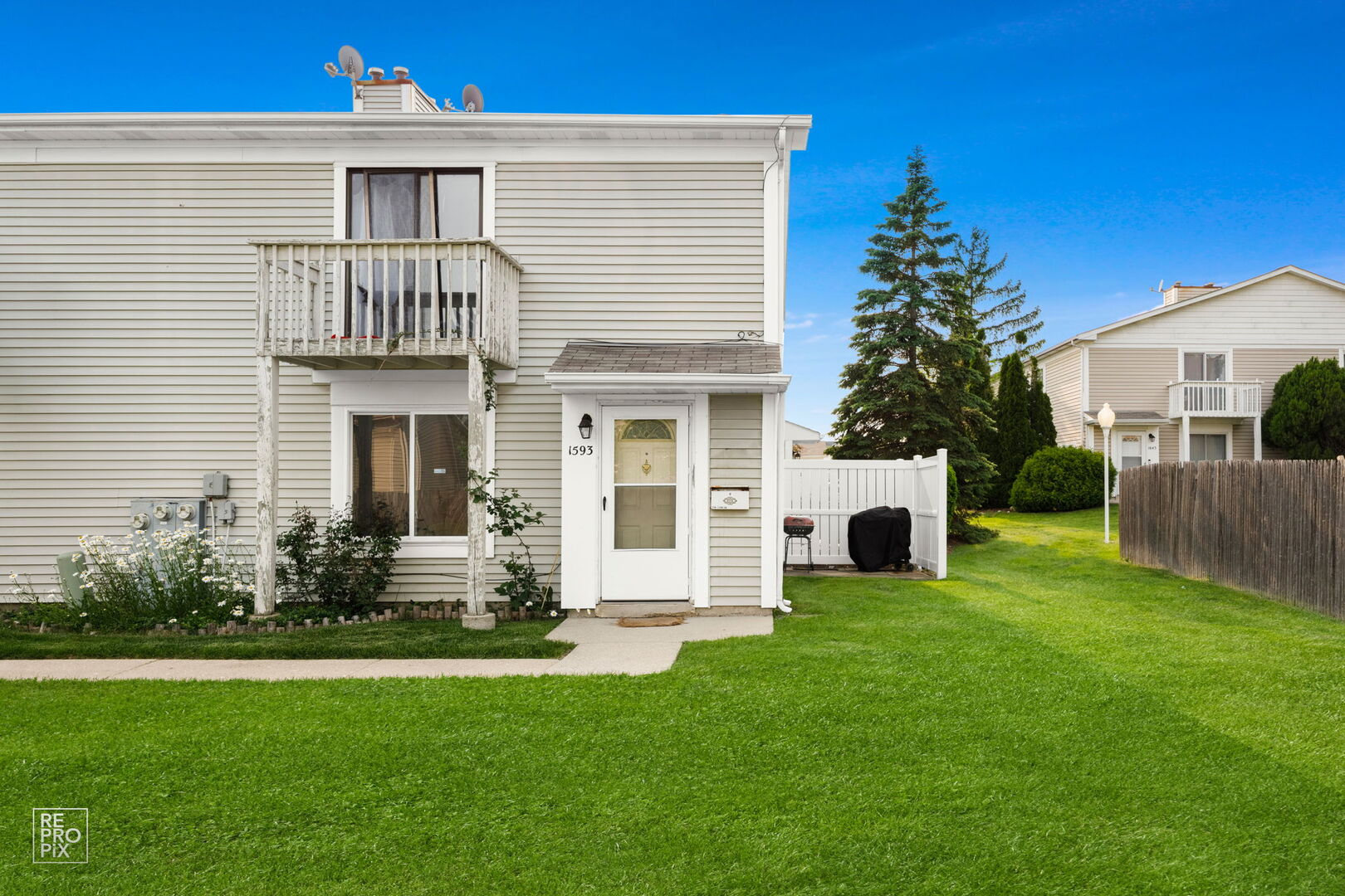 1593 Cornell Place Hoffman Estates, IL 60169 - Photo 2 of 18 a front view of a house with a garden and yard
