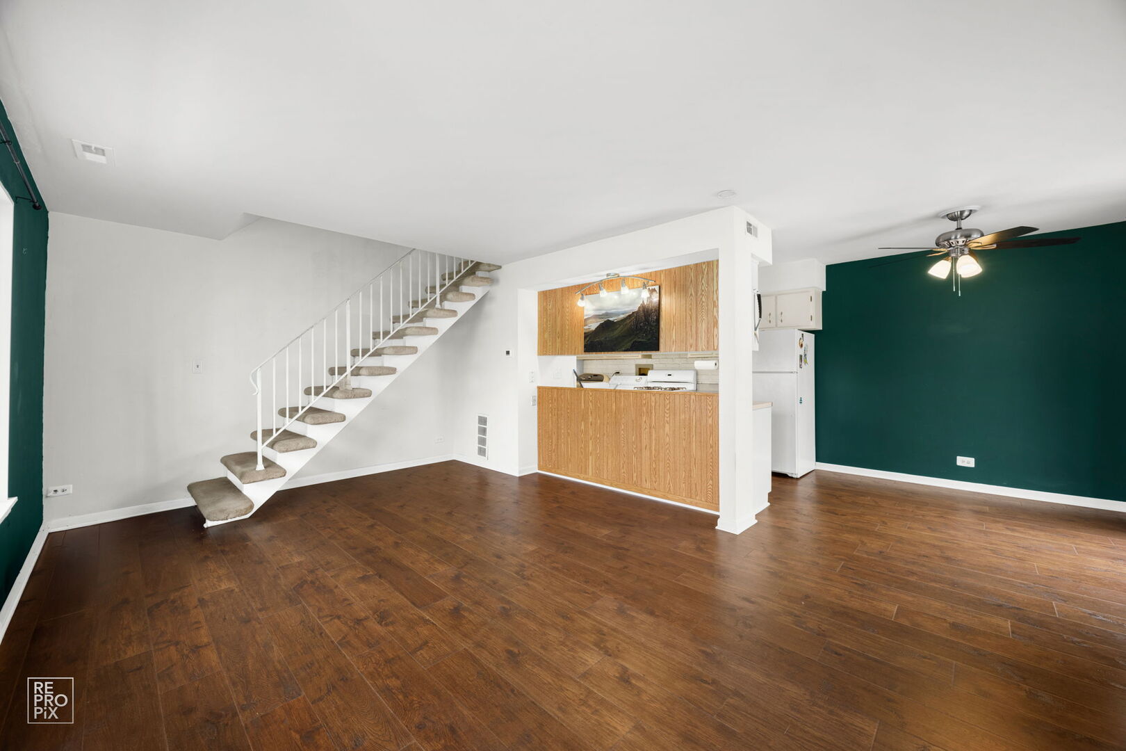 1593 Cornell Place Hoffman Estates, IL 60169 - Photo 3 of 18 a view of an empty room with a kitchen and a fireplace