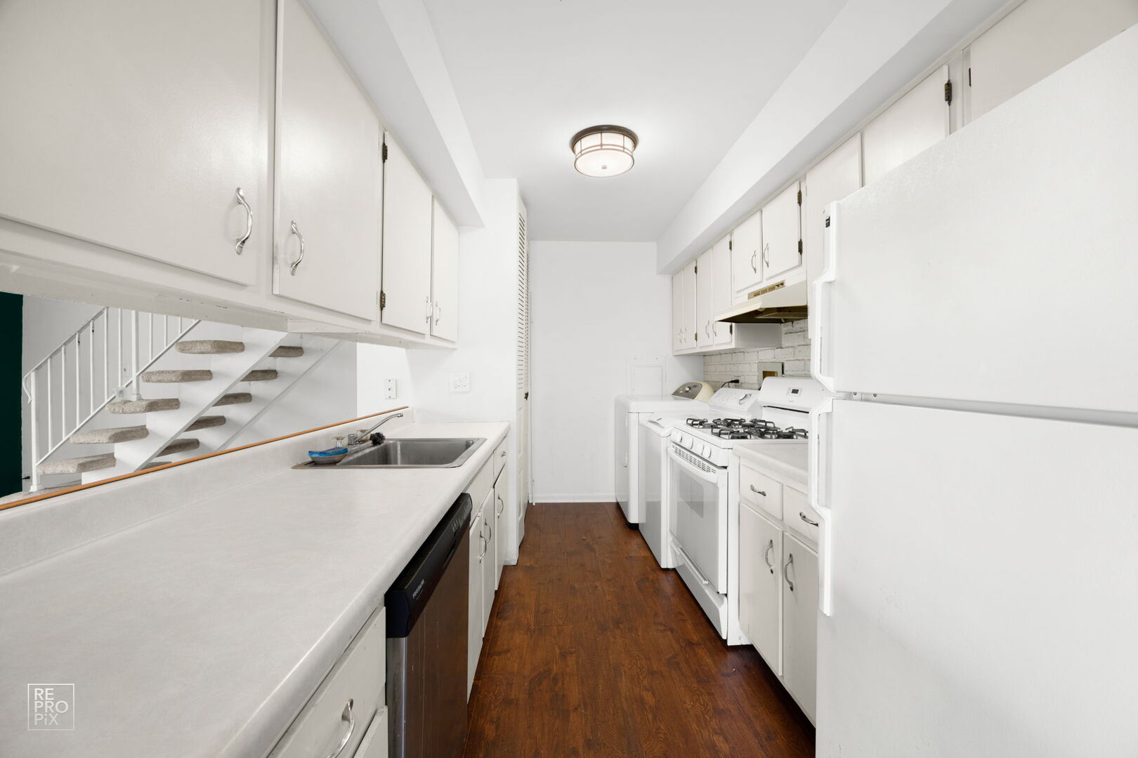 1593 Cornell Place Hoffman Estates, IL 60169 - Photo 6 of 18 a kitchen with stainless steel appliances a stove a sink and white cabinets