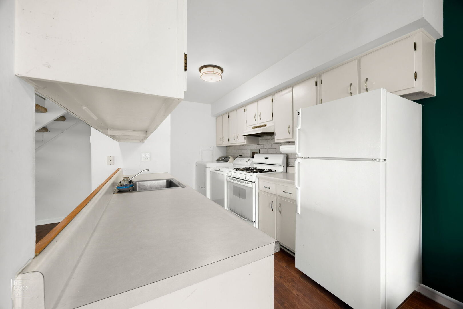 1593 Cornell Place Hoffman Estates, IL 60169 - Photo 7 of 18 a kitchen with white cabinets and white appliances