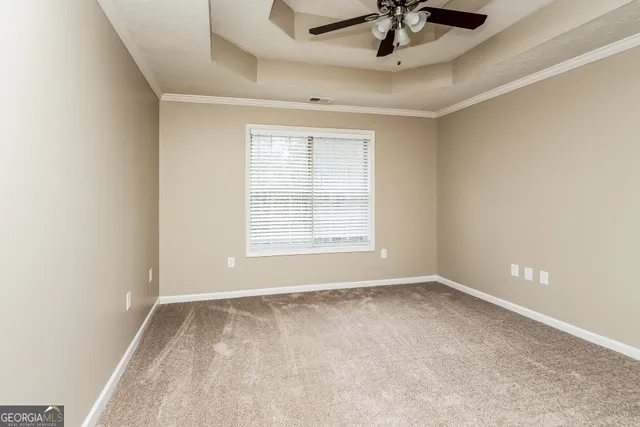 a view of room with ceiling fan and window
