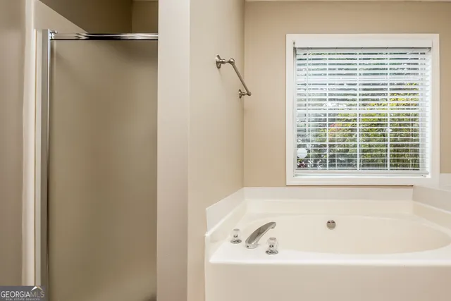 a bathroom with a bathtub and a shower