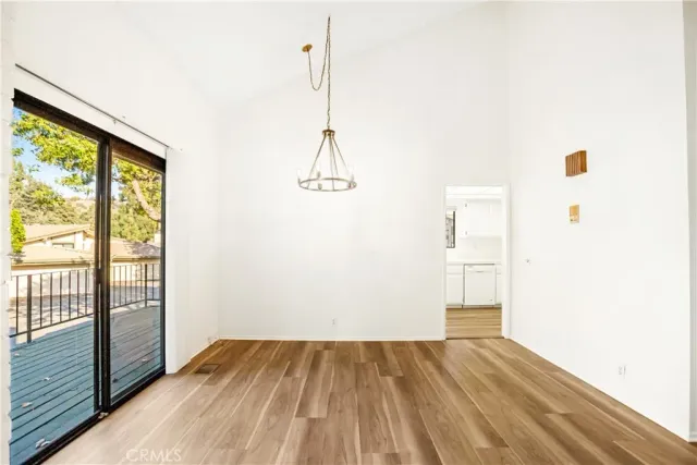 a view of a room with wooden floor and windows