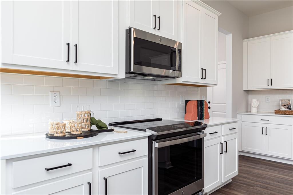 3210 Croftside Commons Powder Springs, GA 30127 - Photo 16 of 57 a kitchen with stainless steel appliances granite countertop white cabinets a microwave oven and a sink