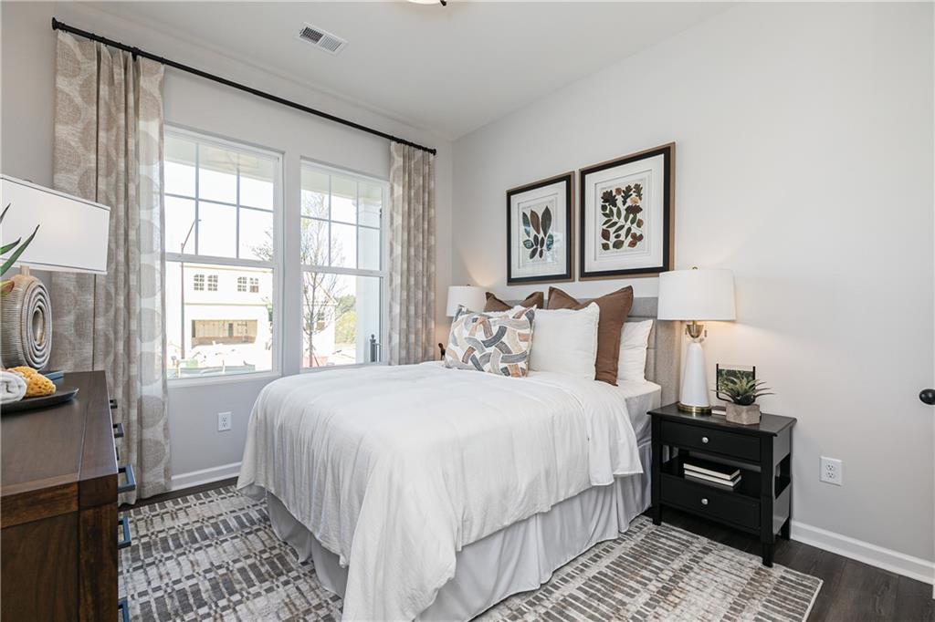 3210 Croftside Commons Powder Springs, GA 30127 - Photo 22 of 57 a bedroom with a bed and wooden floor