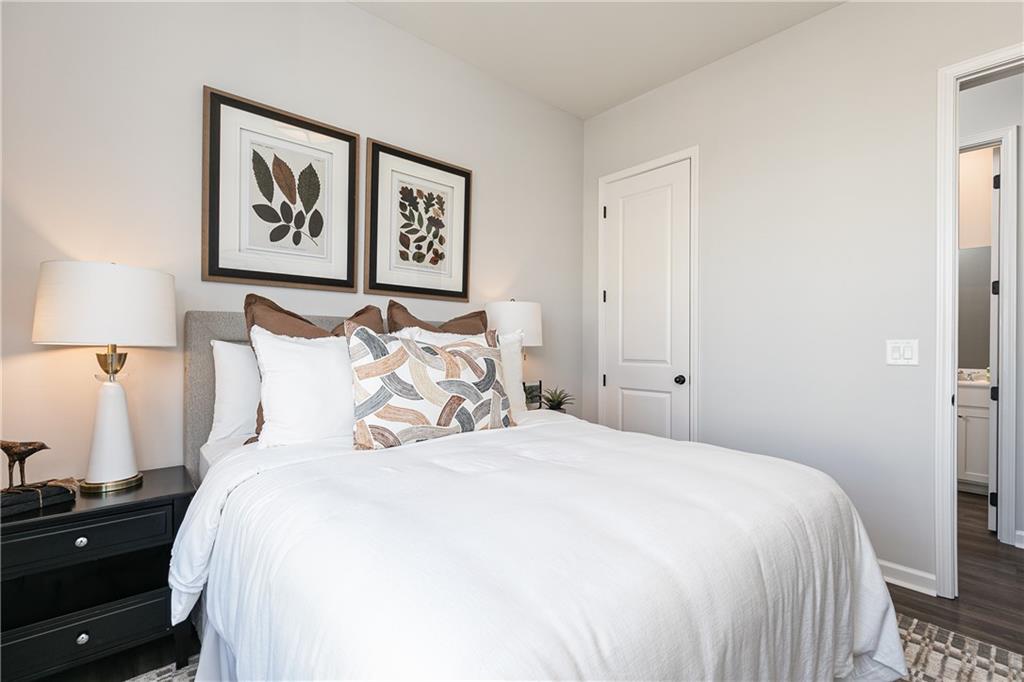 3210 Croftside Commons Powder Springs, GA 30127 - Photo 23 of 57 a bedroom with bed and painting on the wall