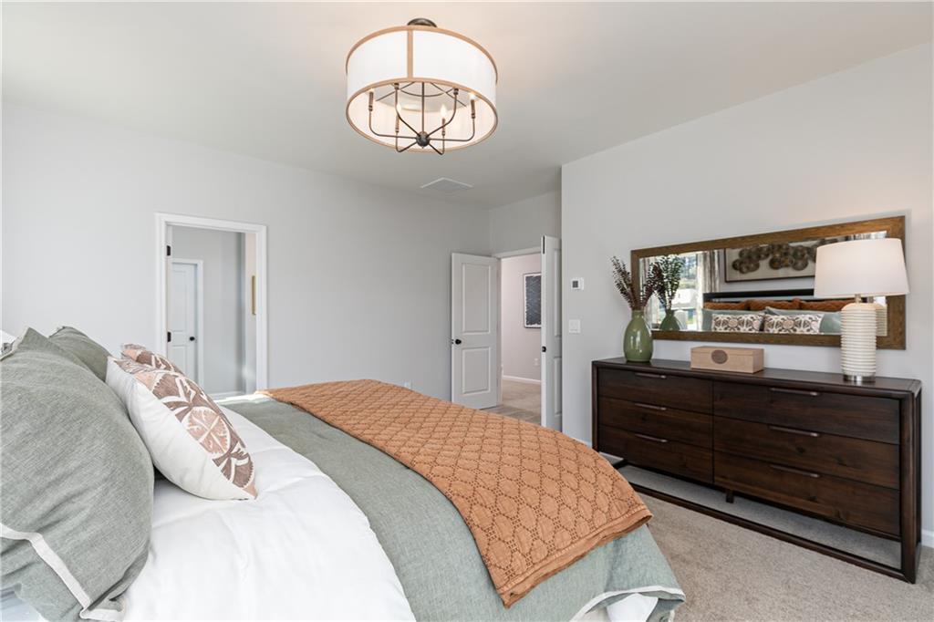 3210 Croftside Commons Powder Springs, GA 30127 - Photo 28 of 57 a bedroom with a bed and wooden floor