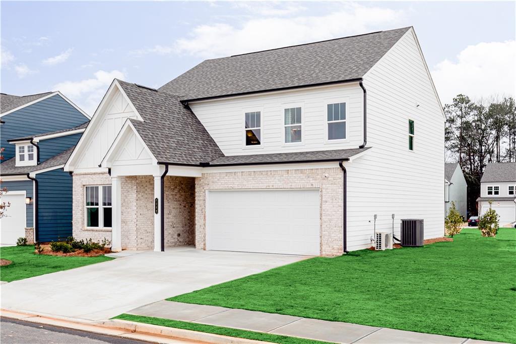 3210 Croftside Commons Powder Springs, GA 30127 - Photo 3 of 57 a view of a white house next to a yard and large trees