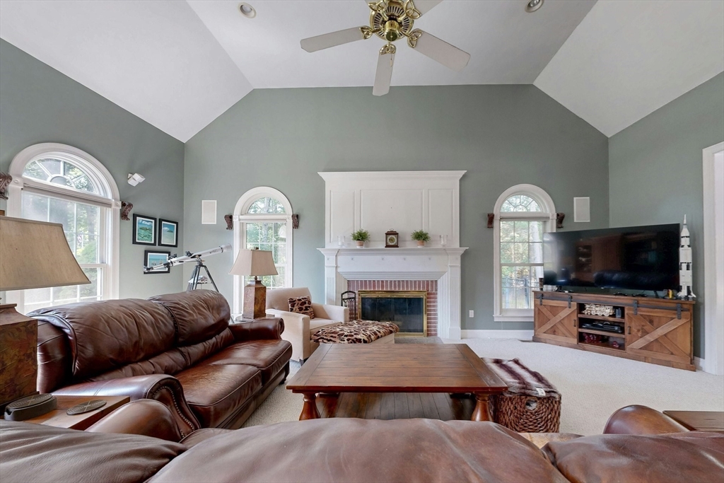 7 Riverbend Road Upton, MA 01568 - Photo 14 of 39 a living room with furniture a fireplace and a flat screen tv