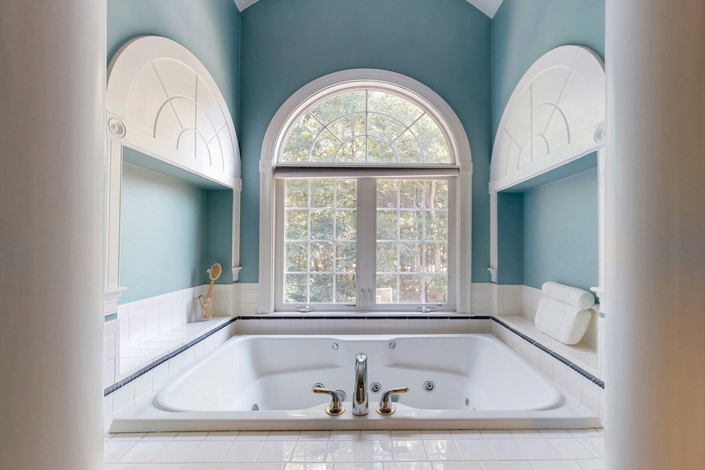 7 Riverbend Road Upton, MA 01568 - Photo 23 of 39 a bath tub sitting in a bathroom next to a window
