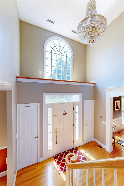 7 Riverbend Road Upton, MA 01568 - Photo 4 of 39 a bedroom with a bed and a chandelier