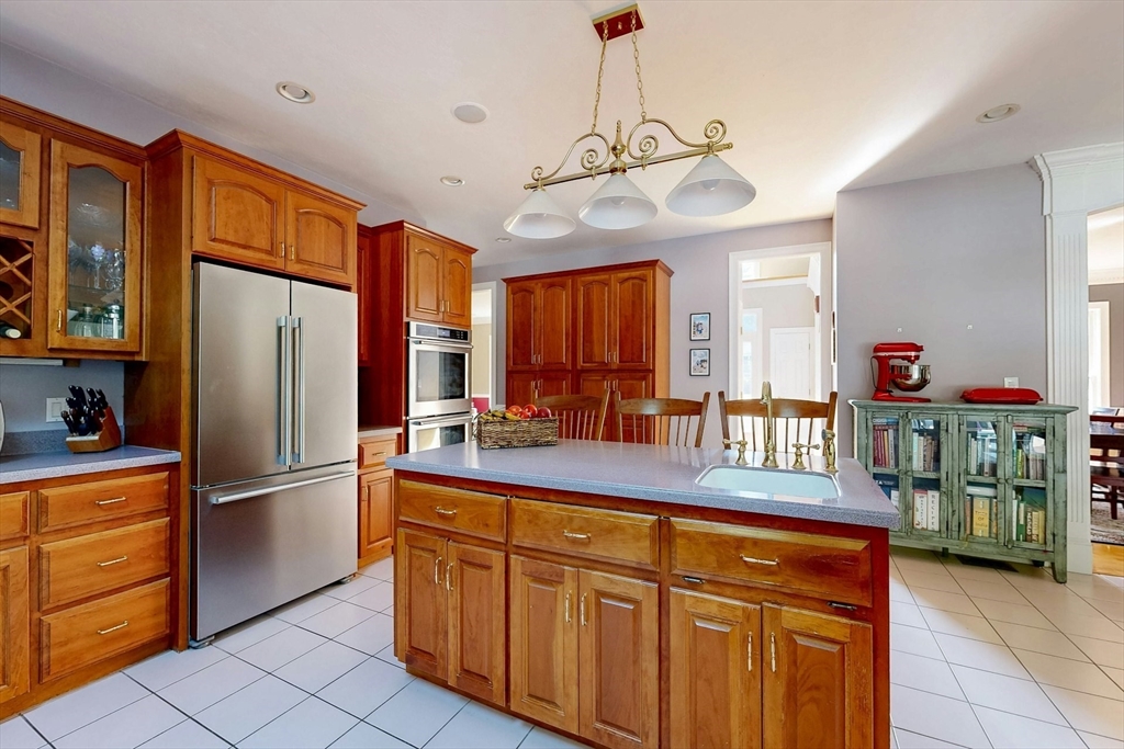 7 Riverbend Road Upton, MA 01568 - Photo 9 of 39 a kitchen with stainless steel appliances granite countertop a refrigerator and a sink