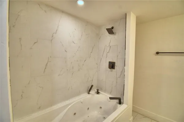 a bathroom with a tub and a shower