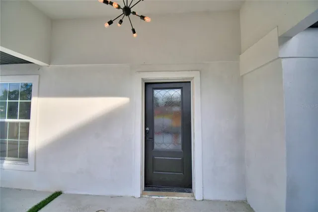 a view of a hallway with closet and a window