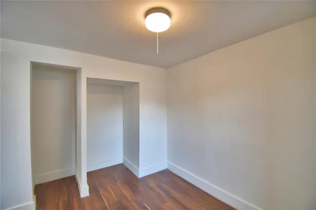 a view of a room with wooden floor and a carpet