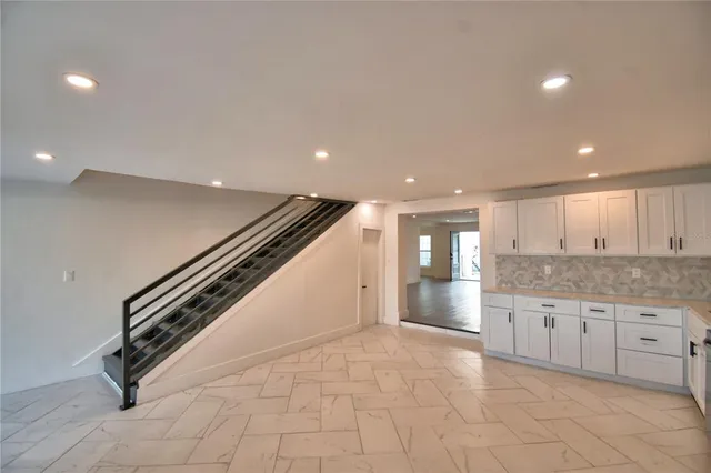 wooden floor and an empty room with a kitchen