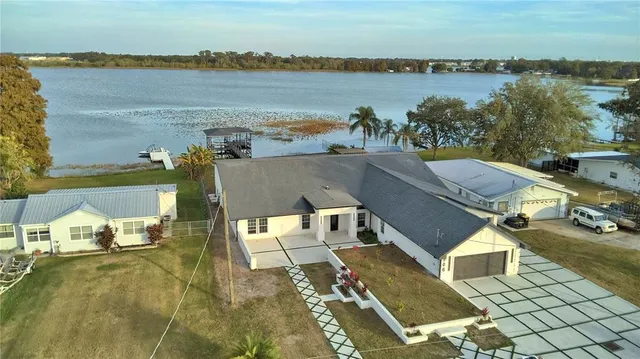 an aerial view of a house with a lake view