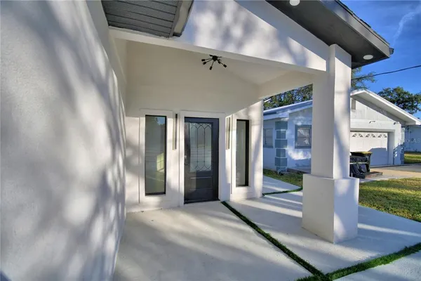 a view of a porch with a table and chairs