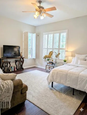 a bedroom with a bed and glass door