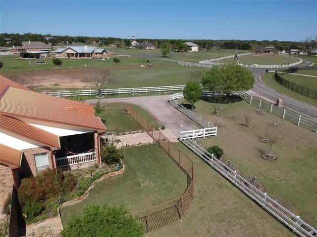 an aerial view of residential houses with outdoor space and lake view