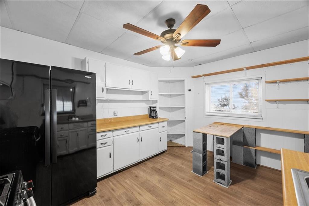 2811 Cobden Street Pittsburgh, PA 15203 - Photo 12 of 32 a kitchen with stainless steel appliances a chandelier and wooden floors