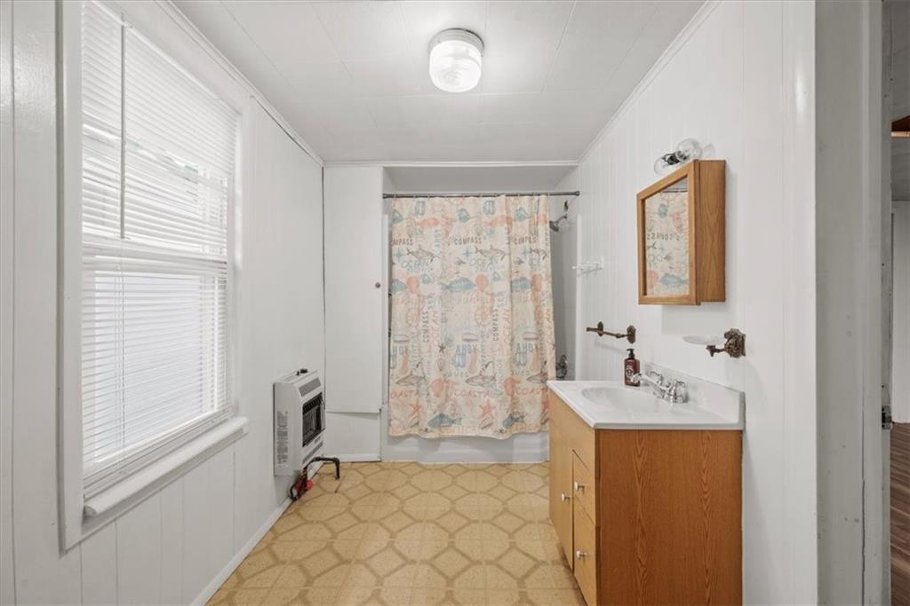 2811 Cobden Street Pittsburgh, PA 15203 - Photo 15 of 32 a bathroom with a sink a mirror and a shower