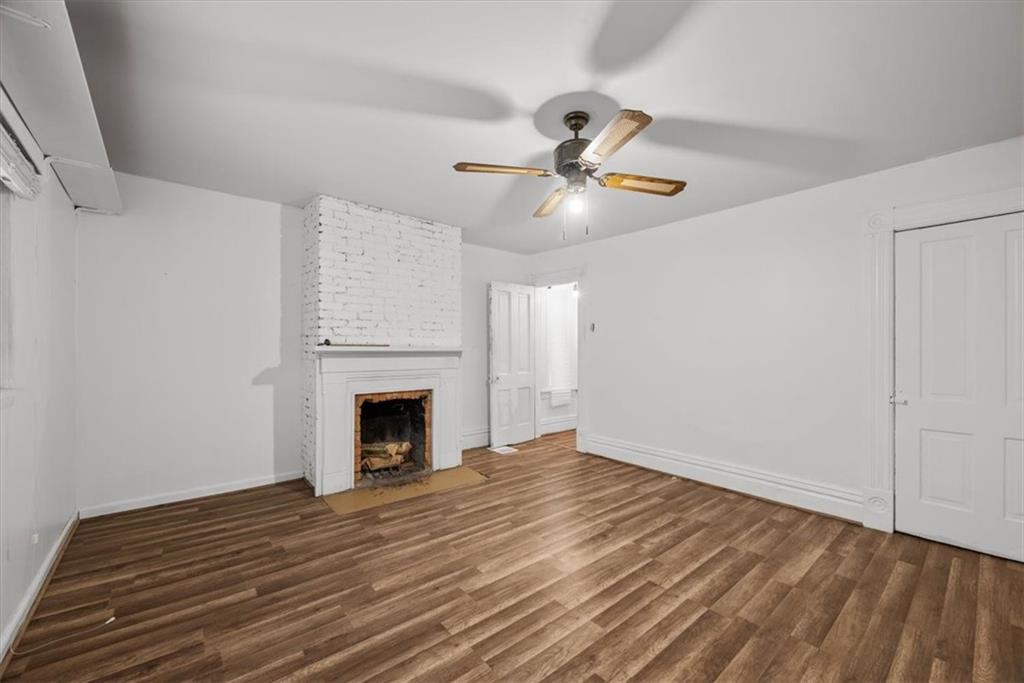 2811 Cobden Street Pittsburgh, PA 15203 - Photo 20 of 32 a view of an empty room with wooden floor fireplace and a window