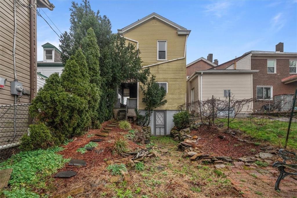 2811 Cobden Street Pittsburgh, PA 15203 - Photo 25 of 32 a view of a yard in front of a house with plants and large tree