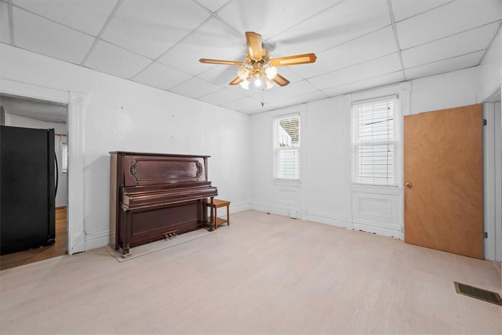 2811 Cobden Street Pittsburgh, PA 15203 - Photo 7 of 32 an empty room with windows and ceiling fan