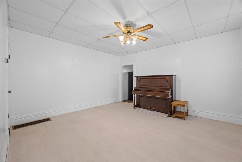 2811 Cobden Street Pittsburgh, PA 15203 - Photo 8 of 32 a room with furniture and a chandelier fan