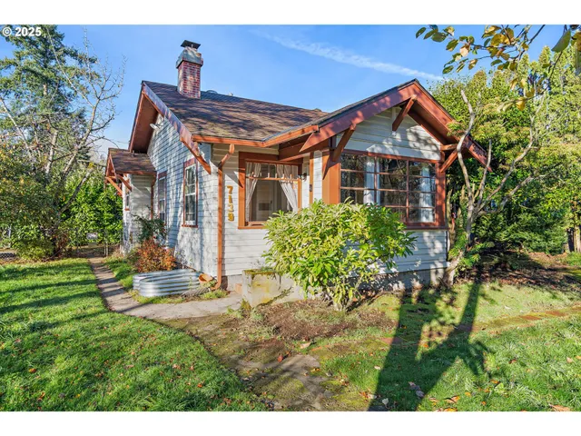 a front view of house with a garden