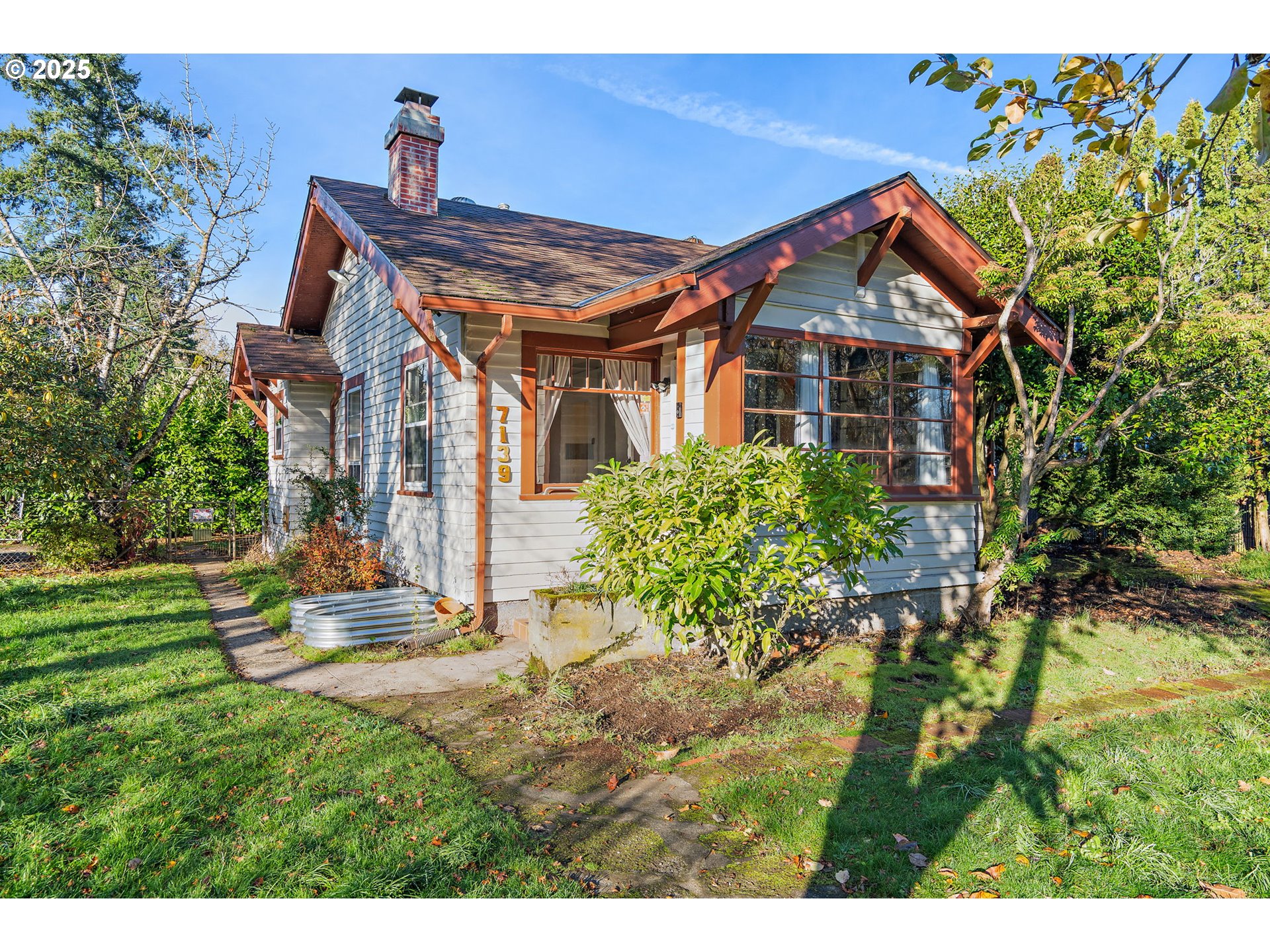 a front view of house with a garden
