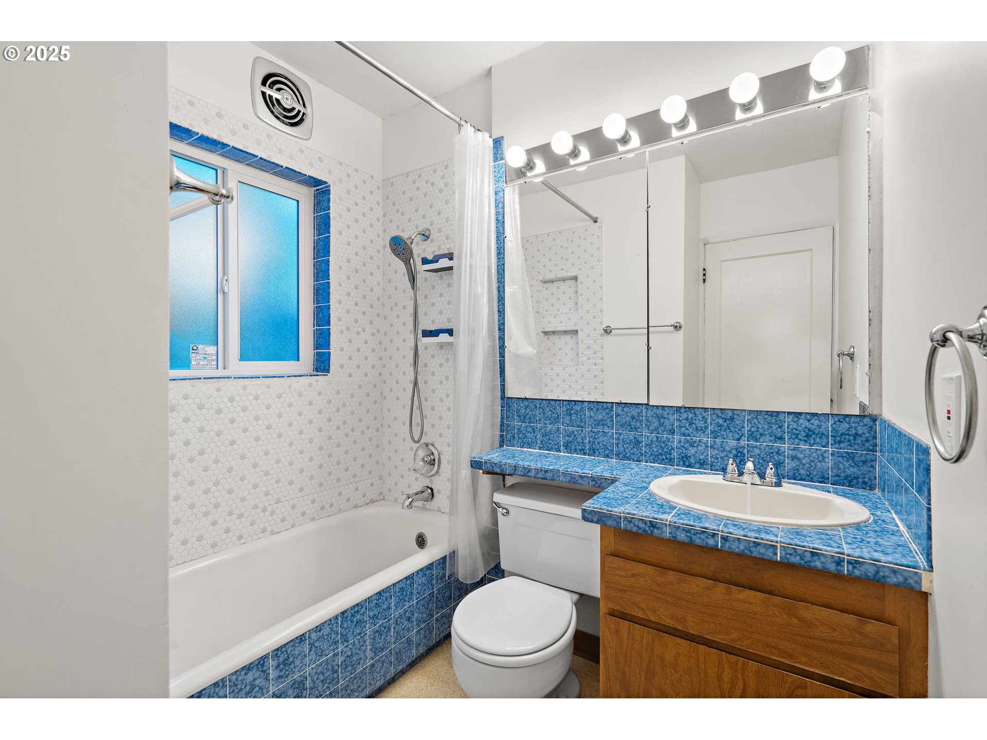 7139 Southeast 78th Avenue Portland, OR 97206 - Photo 19 of 41 a bathroom with a granite countertop sink toilet a large mirror a shower and a bathtub