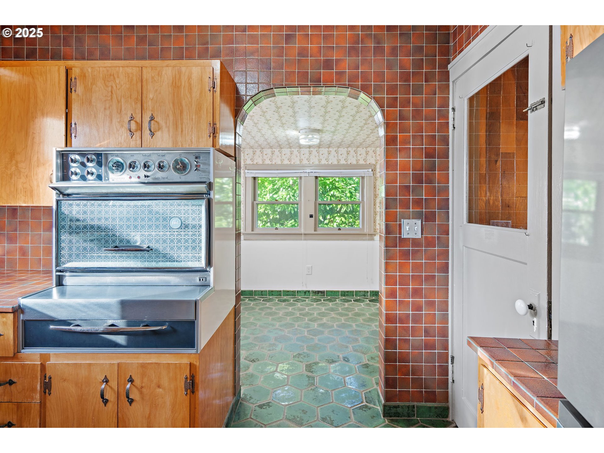 7139 Southeast 78th Avenue Portland, OR 97206 - Photo 8 of 41 a view of a kitchen with kitchen island wooden cabinets and entryway