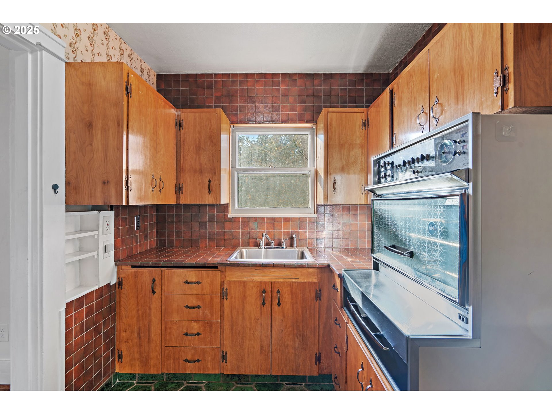 7139 Southeast 78th Avenue Portland, OR 97206 - Photo 10 of 41 a kitchen with kitchen island granite countertop a sink window and cabinets